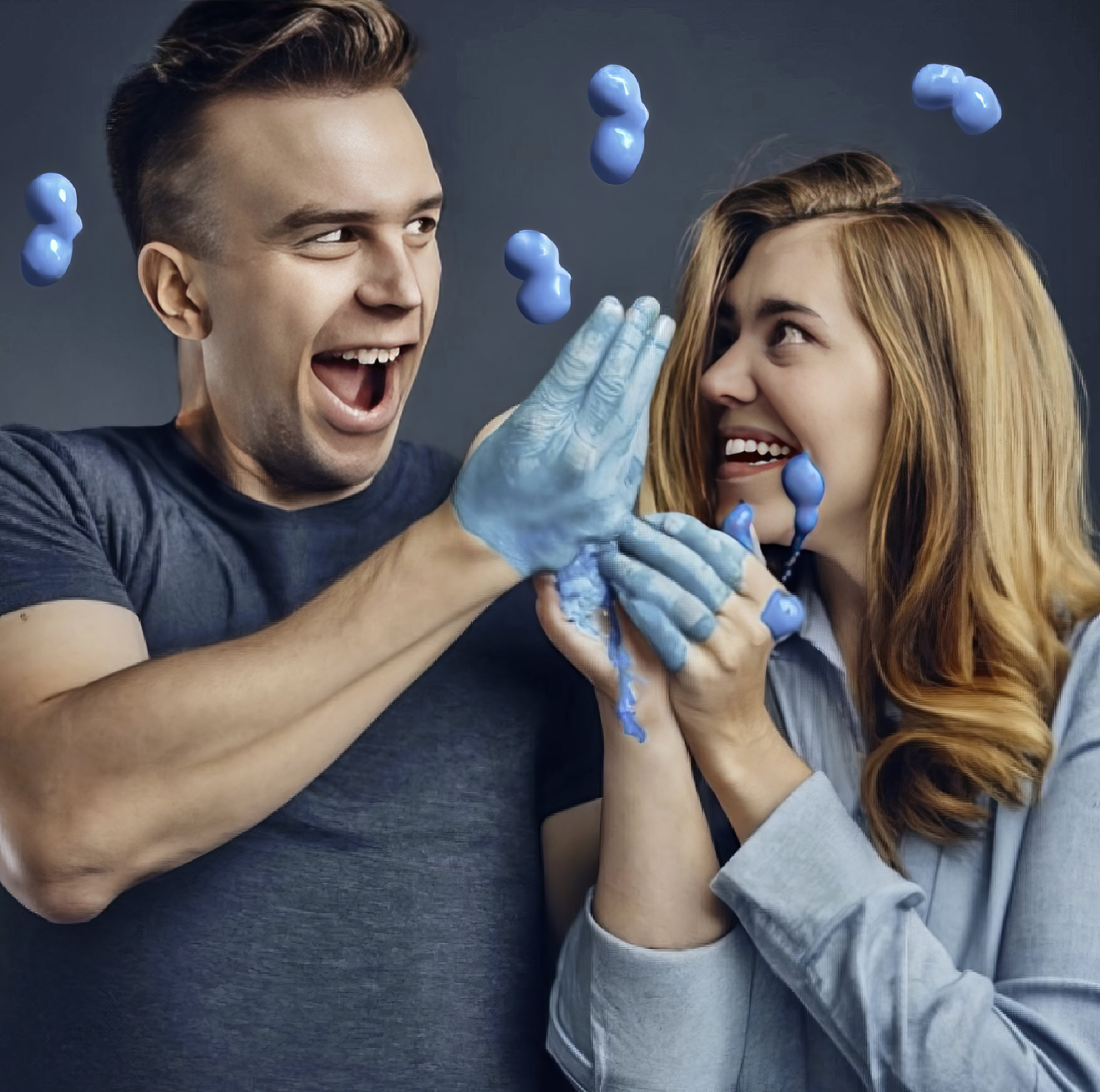 Man and woman with hands covered in blue substance.